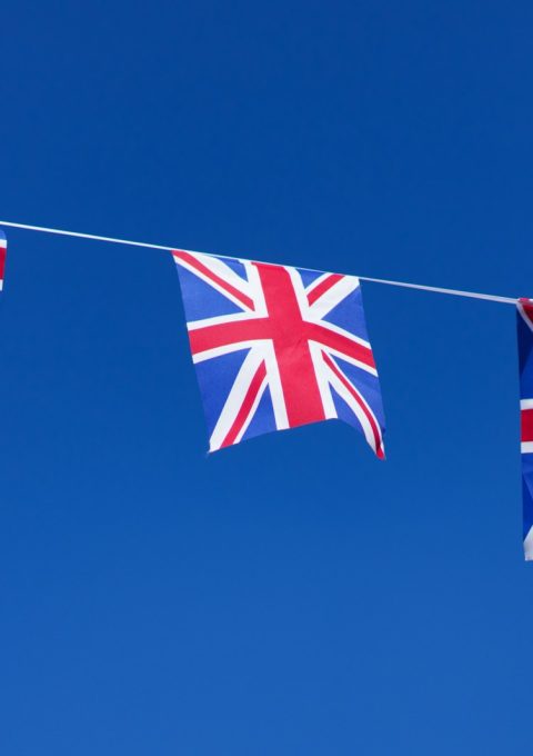 three british flags hanging on a clothes line