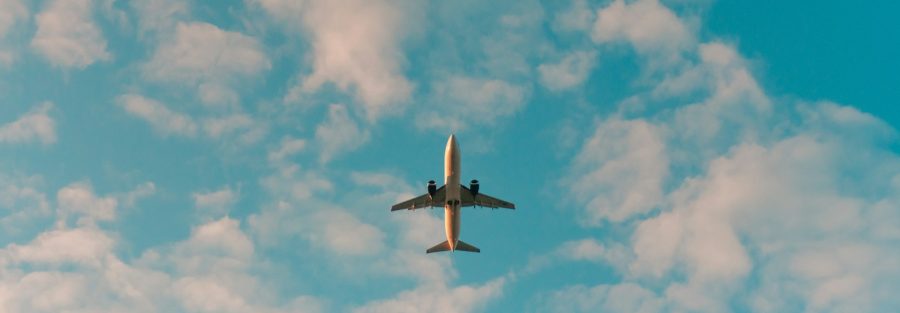 white airplane flying in the sky during daytime